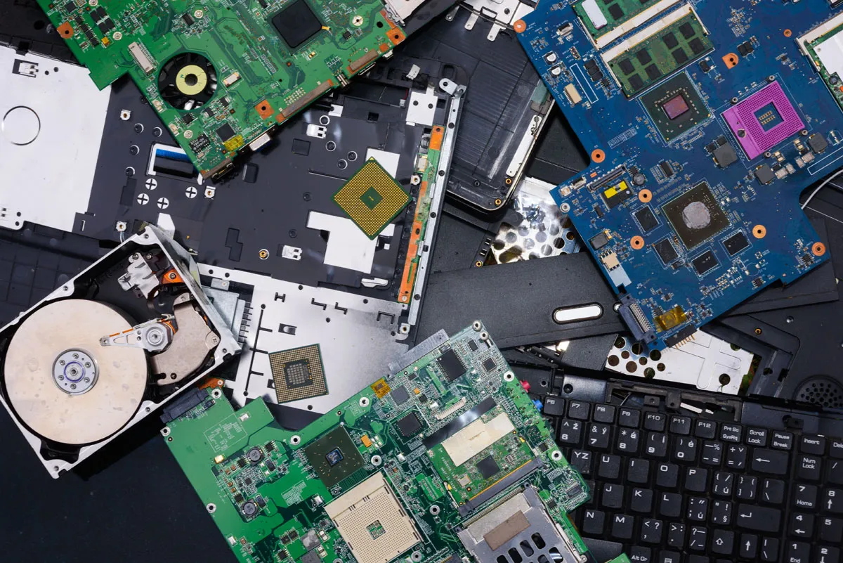 Disassembled computer components prepared for secure data destruction process.
